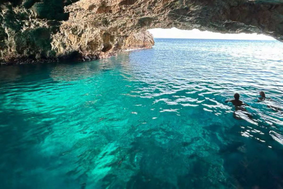 Turquoise water glowing inside the Blue Cave on the Luštica Peninsula, seen from the water